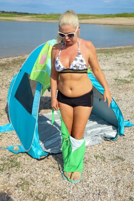 Mature hottie Beth strips on the beach and fingers her hairy cunt