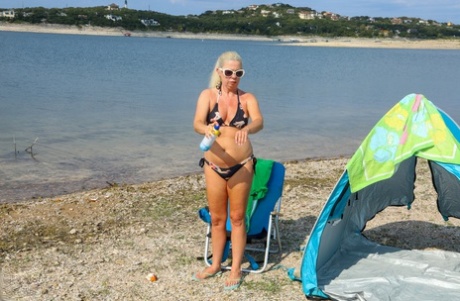 Mature hottie Beth strips on the beach and fingers her hairy cunt