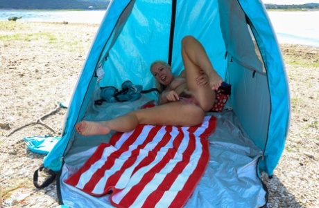 Mature hottie Beth strips on the beach and fingers her hairy cunt
