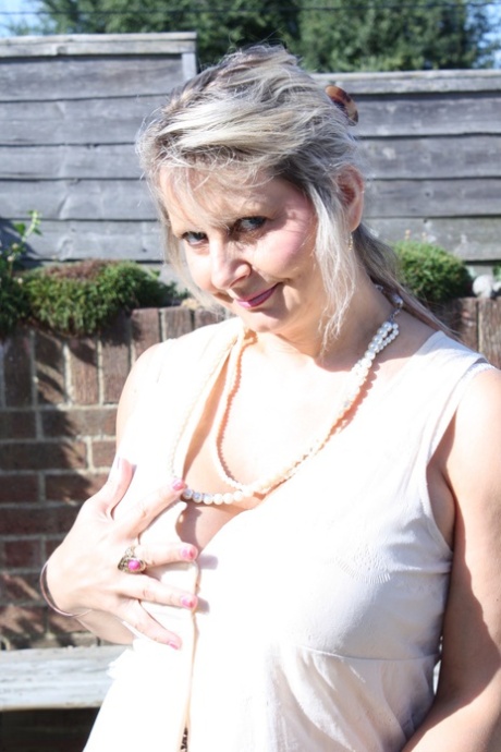Horny mature Alexa undresses and rubs her vagina while teasing with her boobs