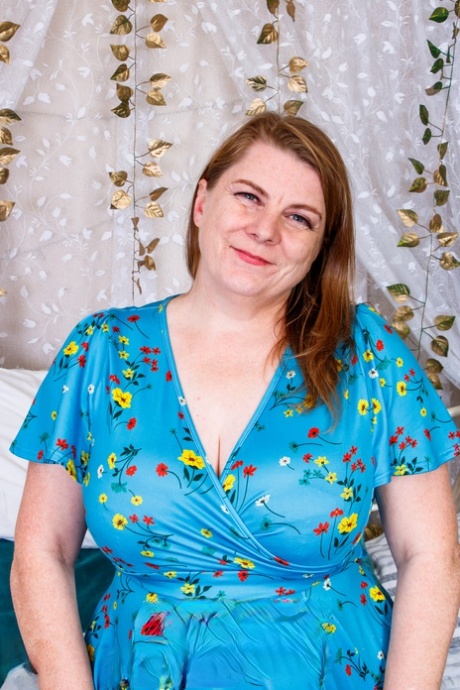 Fat amateur mom Darcy Rosa flashes her hot red undies on a bed in a solo