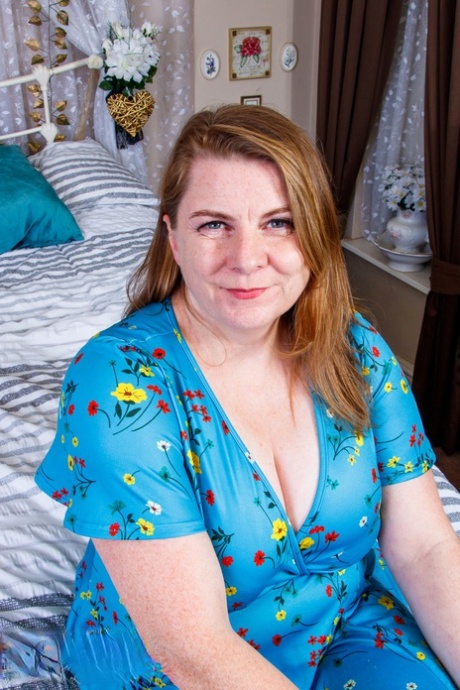 Fat amateur mom Darcy Rosa flashes her hot red undies on a bed in a solo
