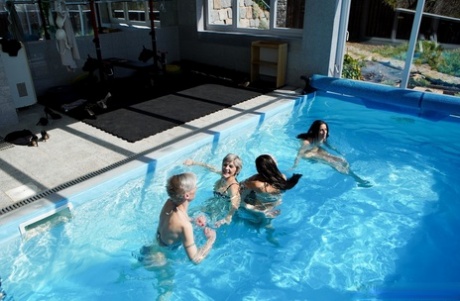 Mature women Valentina Sierra & Belinda Bee fuck young men in a poolside orgy