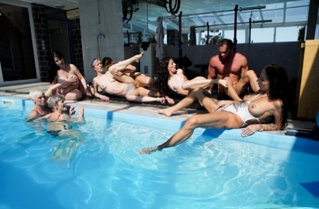 Mature women Valentina Sierra & Belinda Bee fuck young men in a poolside orgy