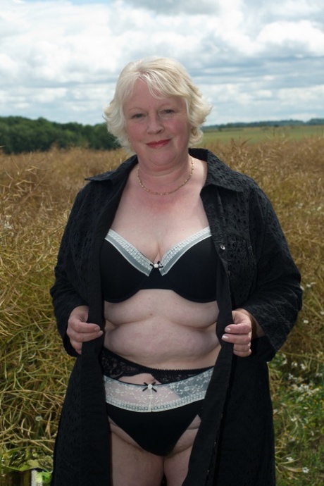 Naughty granny Evelyn S. shows off her chubby naked body outdoors