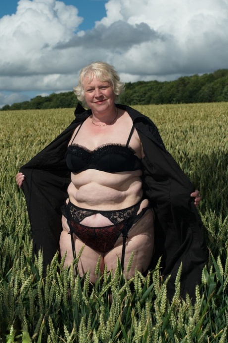 Naughty granny Evelyn S. shows off her chubby naked body outdoors