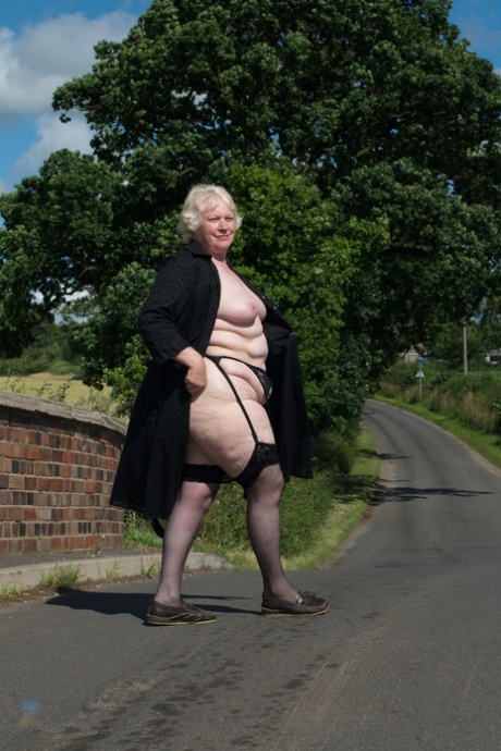Naughty granny Evelyn S. shows off her chubby naked body outdoors