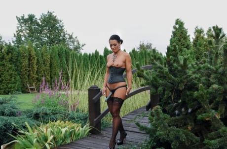 Romanian femdom Sandra Romain slaps and fucks her slave's ass on the bridge