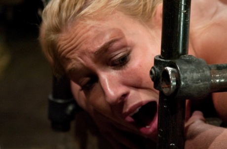 Mature blonde Mellanie Monroe gets fucked by a dildo machine in metal bondage