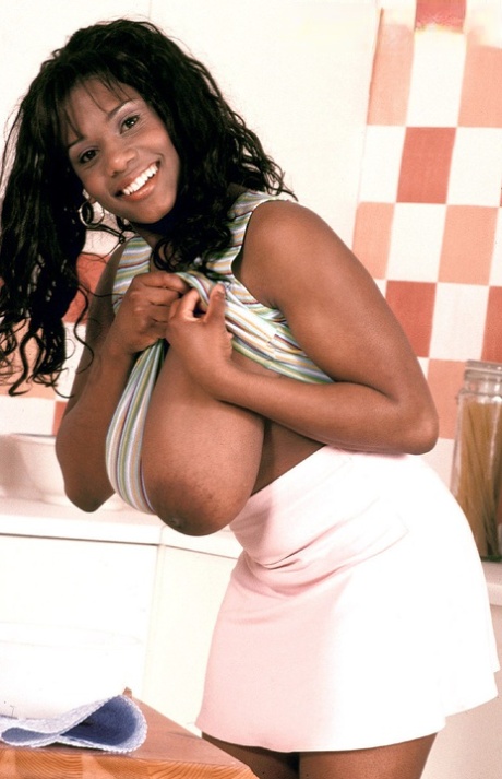 Curvaceous ebony cutie Sammie Black plays with flour and her massive juggs