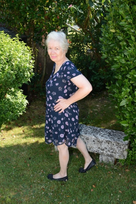 Big boobed granny Caroline stripping on the swing and toying her fat pussy