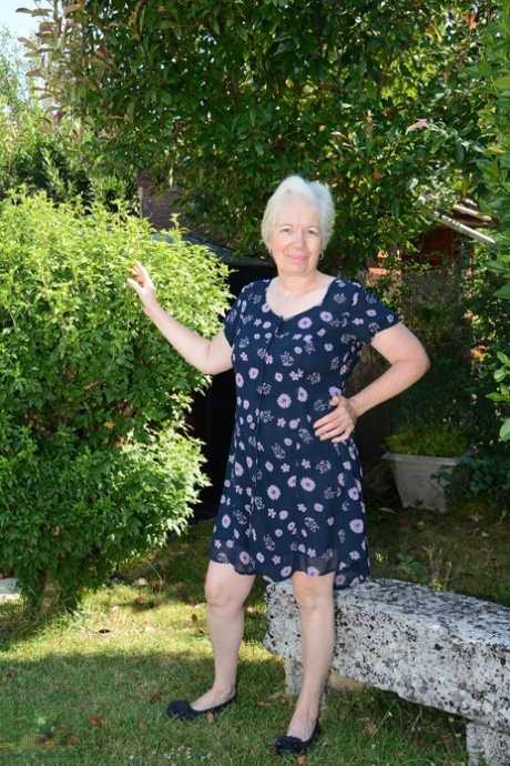 Big boobed granny Caroline stripping on the swing and toying her fat pussy