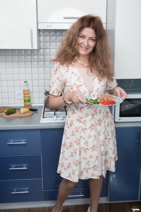 Frisky housewife Elena V inserting tiny cucumbers in her hairy coochie